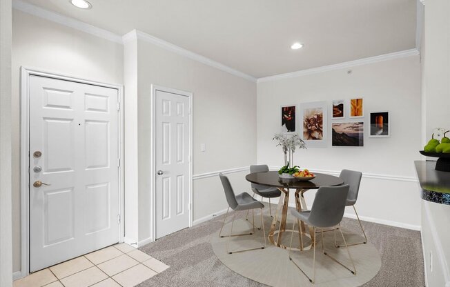 a dining room with a table and four chairs