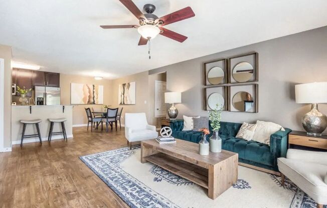 a living room with a couch and a ceiling fan