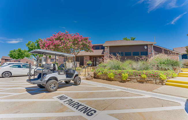 A golf cart is parked in a no parking zone.