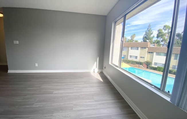 an empty living room with a large window