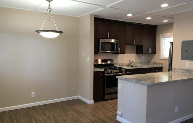 modern kitchen with hard wood and light counters