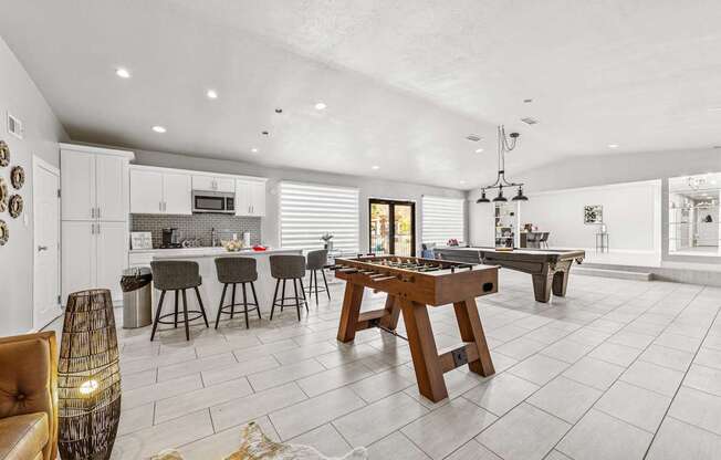 A modern kitchen with a dining table and chairs.