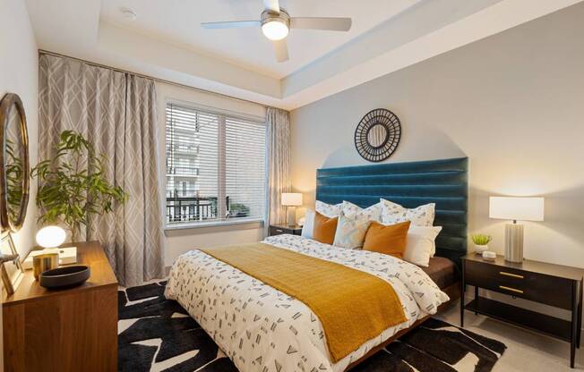 a bedroom with a bed and a blue headboard