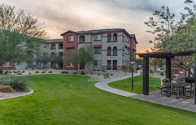 a park with a picnic table in the middle of a grassy area