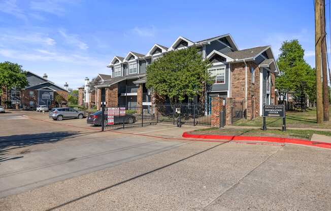 A street view of a residential area with a signboard in the foreground.