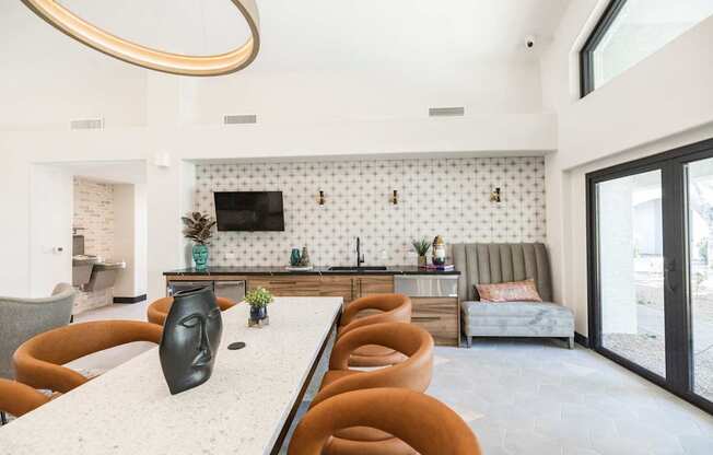 A modern dining room with a white table and brown chairs.