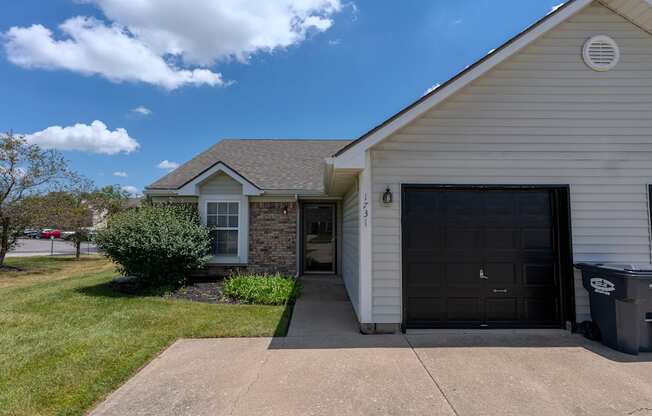 a white house with a driveway and a garage door