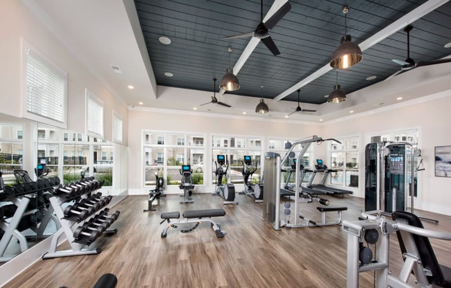 a gym with a black ceiling and wood flooring