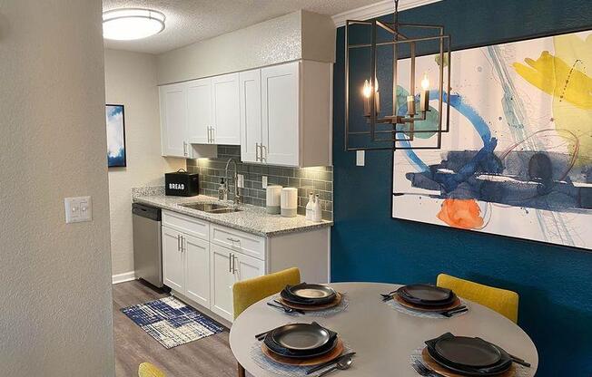 A modern kitchen with a dining table at Latitude at Riverchase, Alabama, 35216