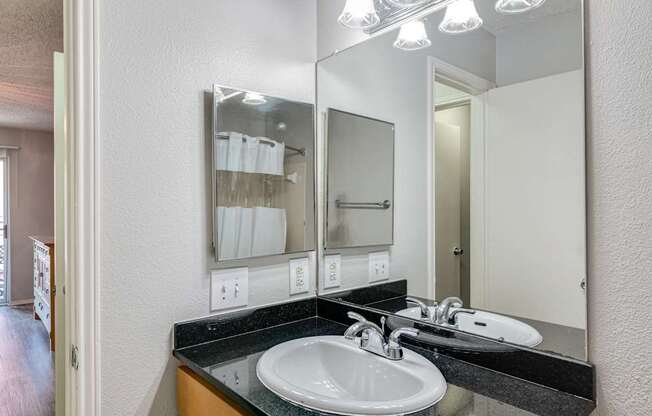 A bathroom with a sink and mirror.