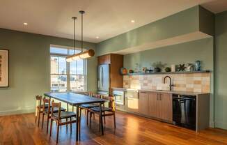 A modern kitchen with a dining table and chairs.