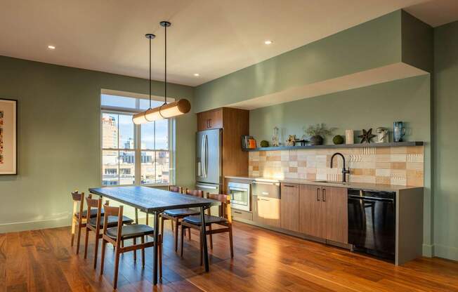A modern kitchen with a dining table and chairs.