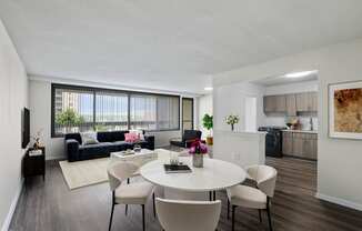 Skyline Towers spacious apartment with a living room and dining room with a white table and chairs