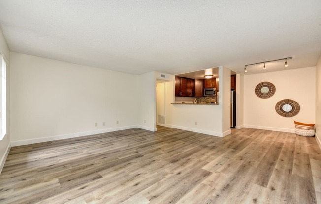 Vacant apartment home located on the first floor with hardwood inspired flooring through out with views of the open concept kitchen and dining area. 