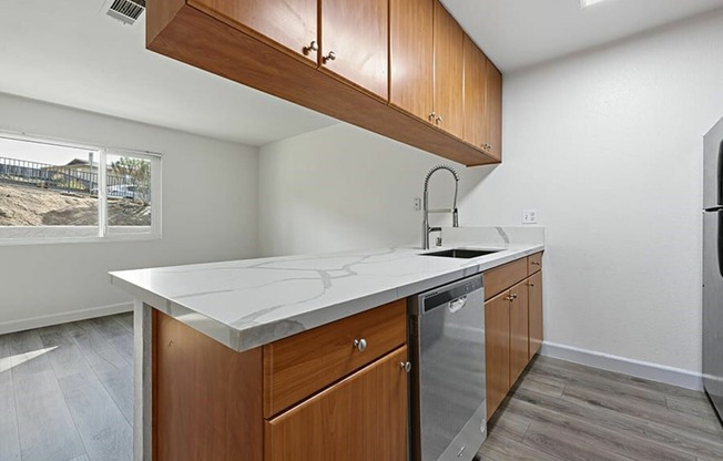living room and kitchen with vinyl wood like flooring and stainless steel appliances
