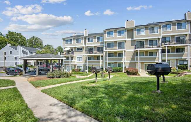 Apartment complex with a walkway in front.