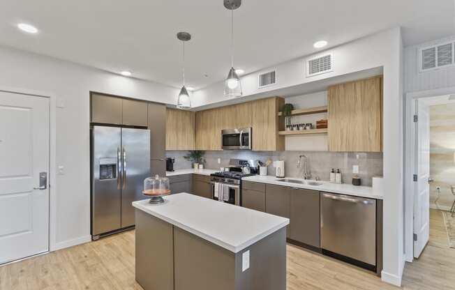 Kitchen with wood floors and stainless steel appliances at Array La Mesa, La Mesa
