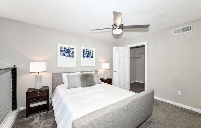 a bedroom with a bed and a ceiling fan