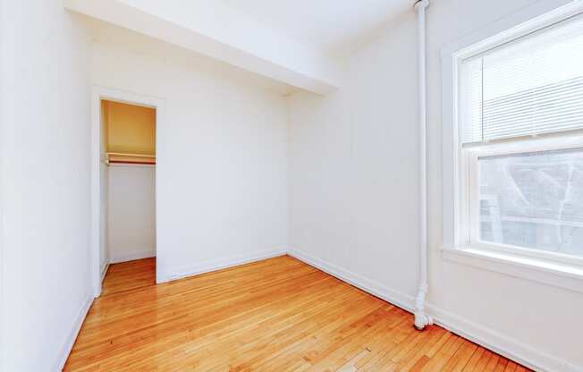 Cozy Bedroom with Restored Hardwood Floors and a Large Windows at The Park Apartments in Minneapolis, 55403