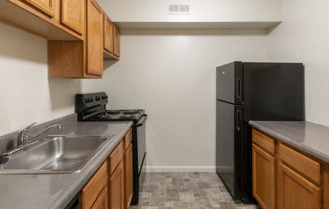 This is a photo of the kitchen of the 902 square foot, 2 bedroom, 1 and a half bath apartment at Blue Grass Manor Apartments in Erlanger, KY.