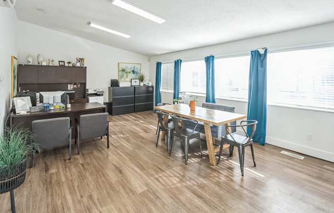 an open living room and dining room with a table and chairs