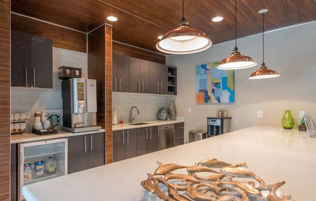 a kitchen with stainless steel appliances and a white counter top