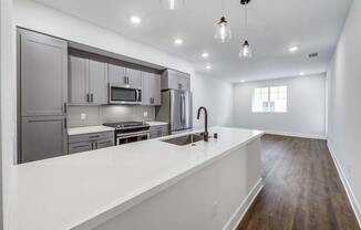 a kitchen with a sink and a stove in a house  at The Vineyards Apartments, California, 91326