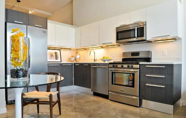 a kitchen with stainless steel appliances and a glass table