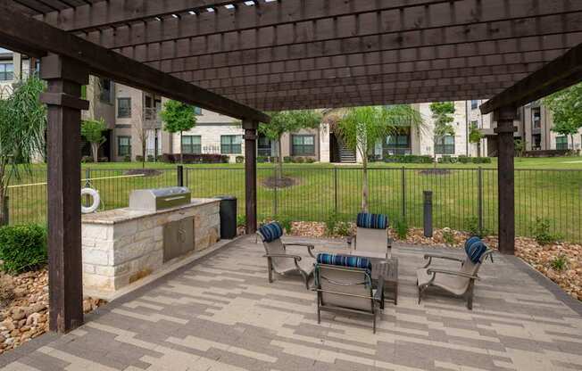 A patio with a table and chairs under a roof.