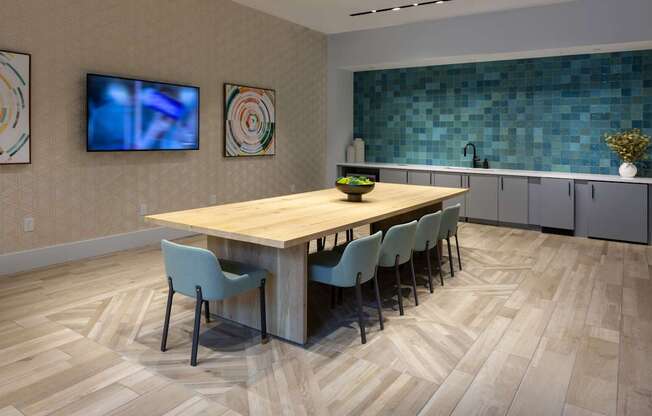 a dining room with a wooden table and chairs