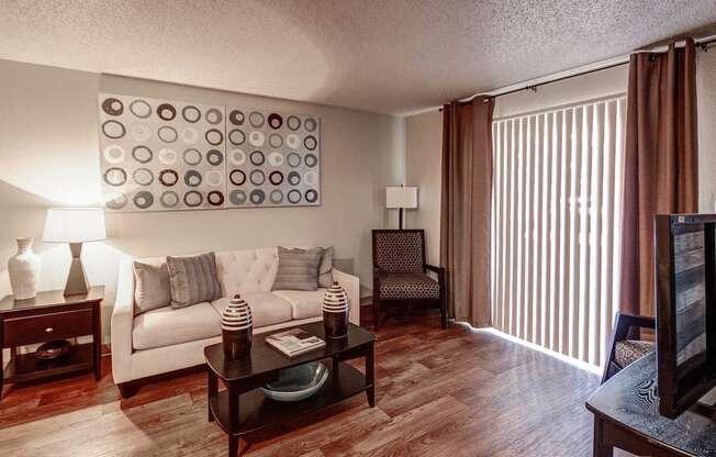 Living Room with Wood Style Flooring at University Village Apartments, Colorado Springs, CO, 80918