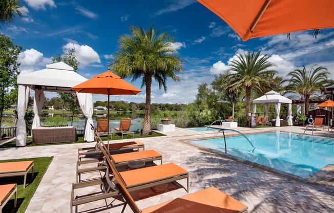 Swimming Pool Area With Shaded Chairs at Town Trelago, Maitland, FL