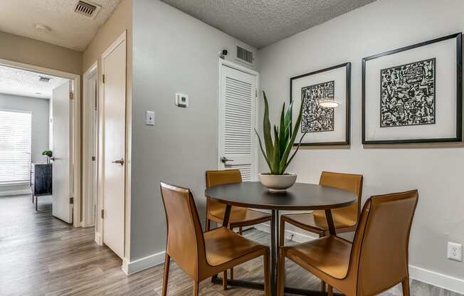 a dining room with a table and chairs