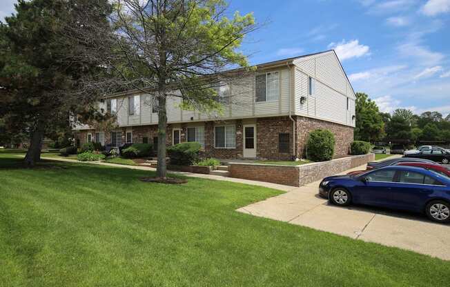 a house with a blue car parked in front of it at Village Club of Rochester Hills, Shelby Township, 48317