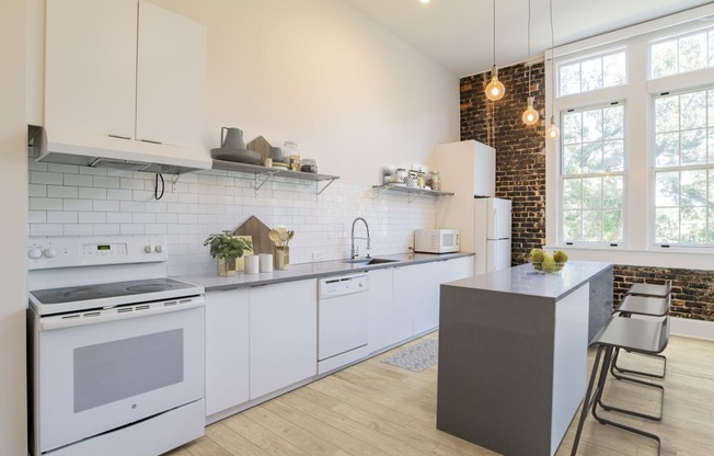 a white kitchen with white appliances and a counter top