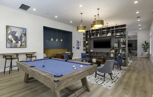 a clubhouse with a pool table and a tv