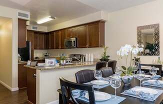 A kitchen with a dining table set for two.