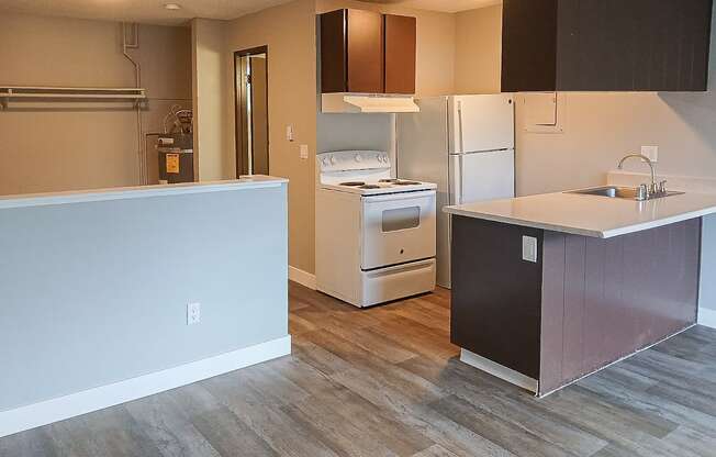 A kitchen with a white fridge and a white stove top oven.