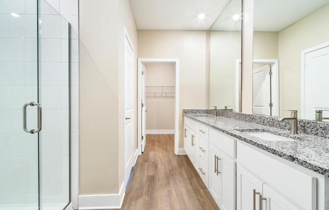 A spacious primary bath at Amavi Kissimmee offers dual vanities with generous storage and thoughtful design.
