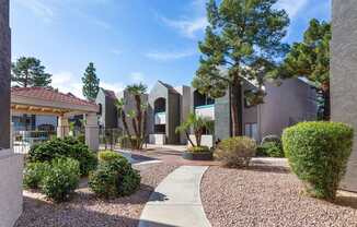 A modern building with a gravel pathway in front.