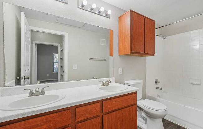 A bathroom with a white sink and a white toilet.