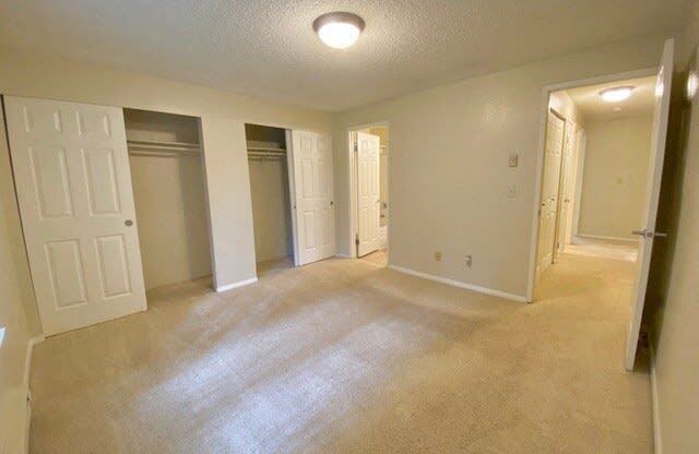 an empty living room with an open door