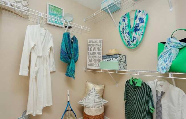 a closet with clothes and accessories hanging on the wall