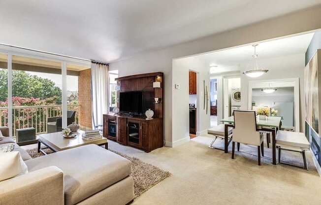 A living room with a white couch and a television.