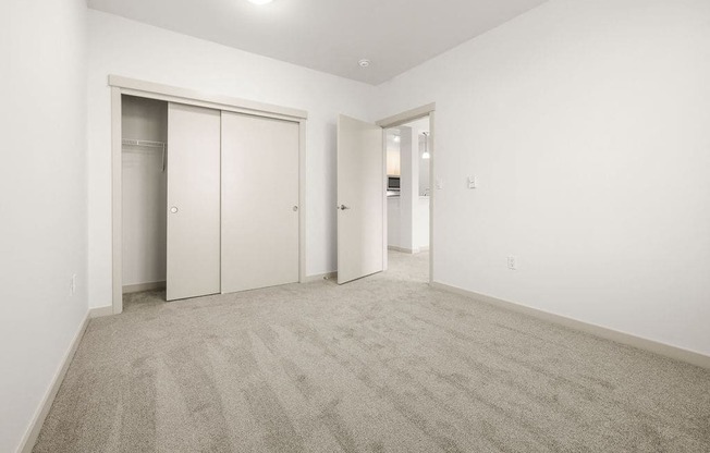 A room with carpeted floor and white walls.