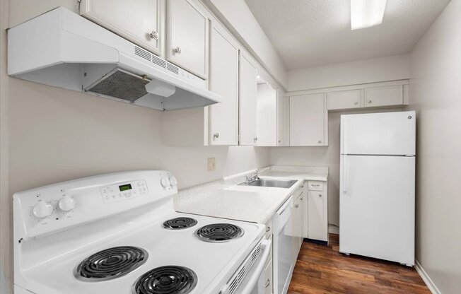 a white kitchen with white appliances and white cabinets