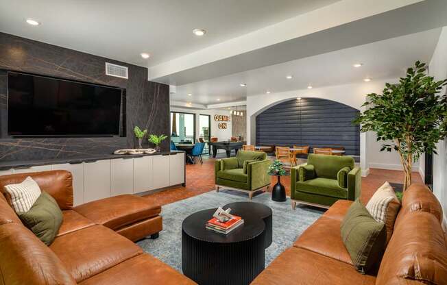 A living room with brown leather couches and a black coffee table.