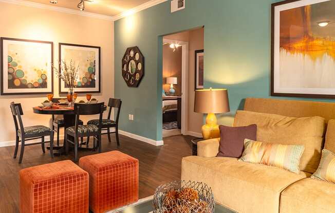 a living room with blue walls and orange furniture