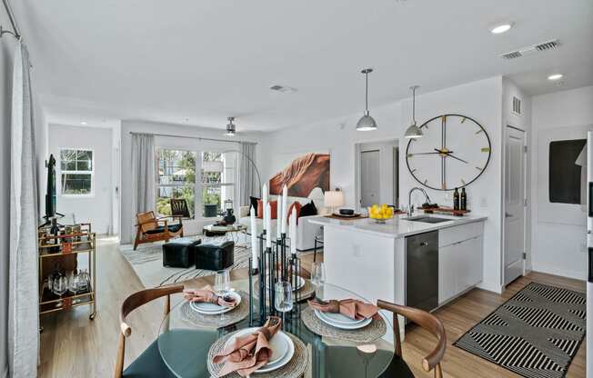 a living room and kitchen with a large clock on the wall at Altis Grand Suncoast, Florida