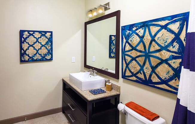 a bathroom with a white sink and blue tiles on the walls